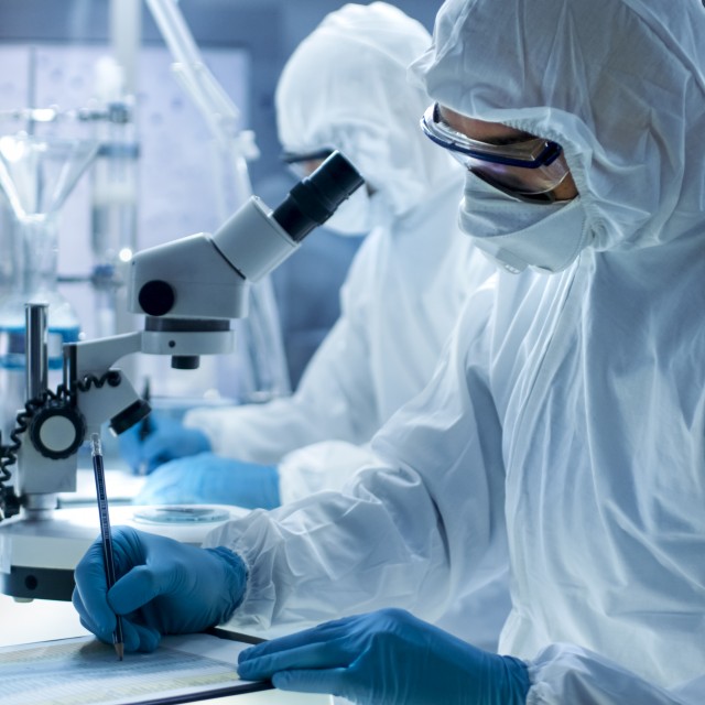Scientists wearing protective suits in the lab
